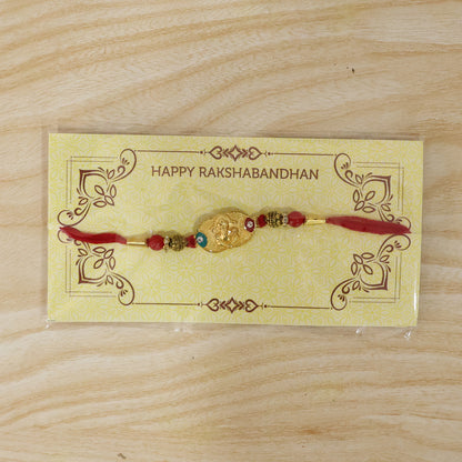 Golden Ganesh Rakhi for Boys with Red and Green Beads