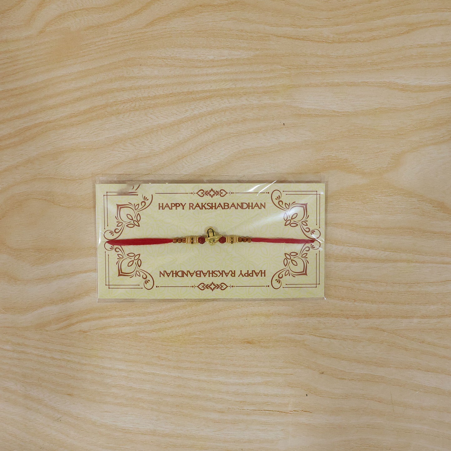 Lord Shiva Shivling Trishul Devotional Rakhi with Golden Temple Centre and Red Thread