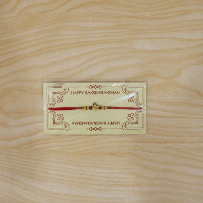 Lord Shiva Shivling Trishul Devotional Rakhi with Golden Temple Centre and Red Thread