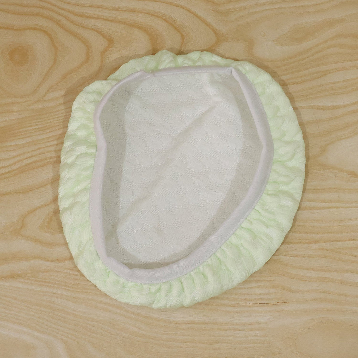 Textured round stool cushion cover folded, showcasing texture