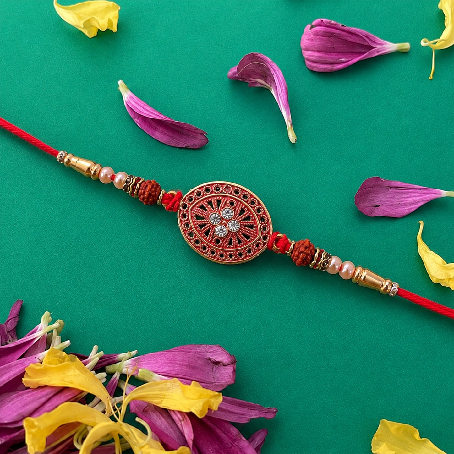 Round Red Chakra Rakhi with Golden Beads and Pearl Side Work