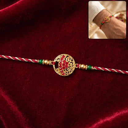 Golden Red Diamond Om Trishul Rakhi with Green Beads and Twisted Thread