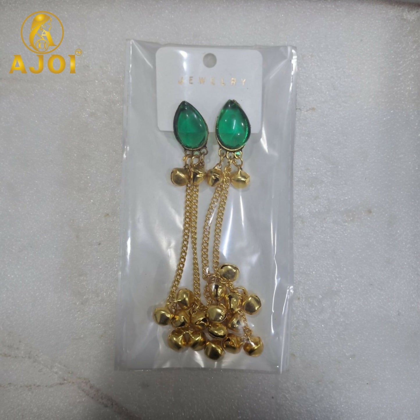 Back view of a green stone gold plated drop earring, showing the hook