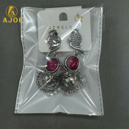 Antique silver peacock jhumka earrings styled with ethnic outfit