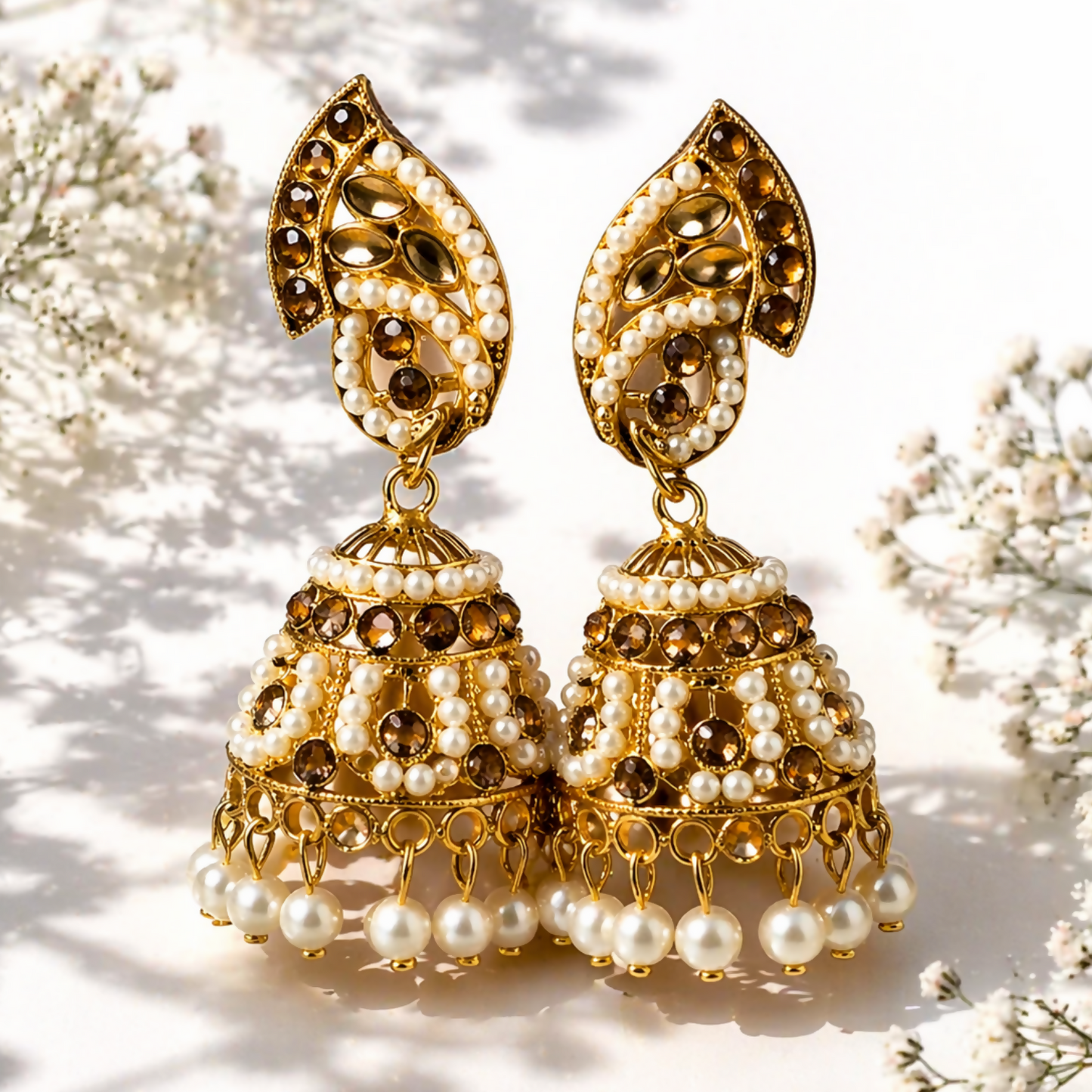 Front view of gold plated pearl and stone jhumka earrings