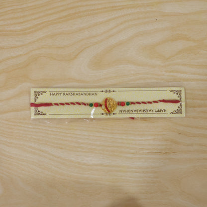 Golden Red Diamond Om Trishul Rakhi with Green Beads and Twisted Thread