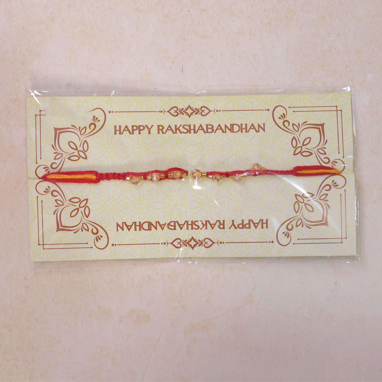 Red Braided Rakhi with Crystal Bead Pendant and Golden Accents