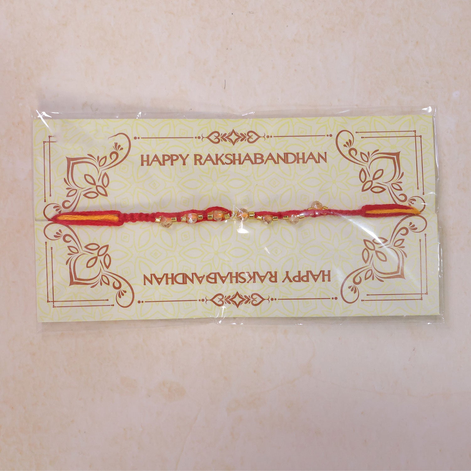 Red Braided Rakhi with Crystal Bead Pendant and Golden Accents