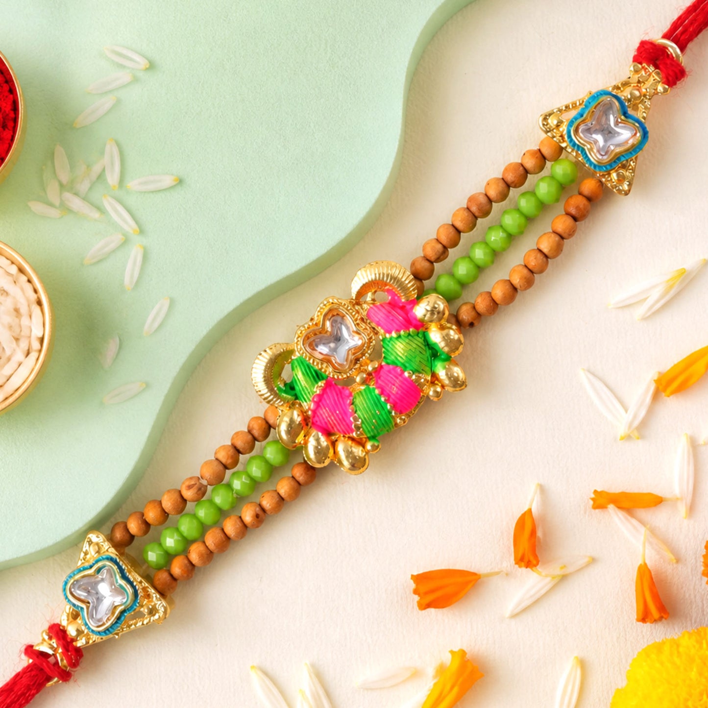 Green Beaded Floral Rakhi with Pink Center and Colorful Festive Gifting Elegance