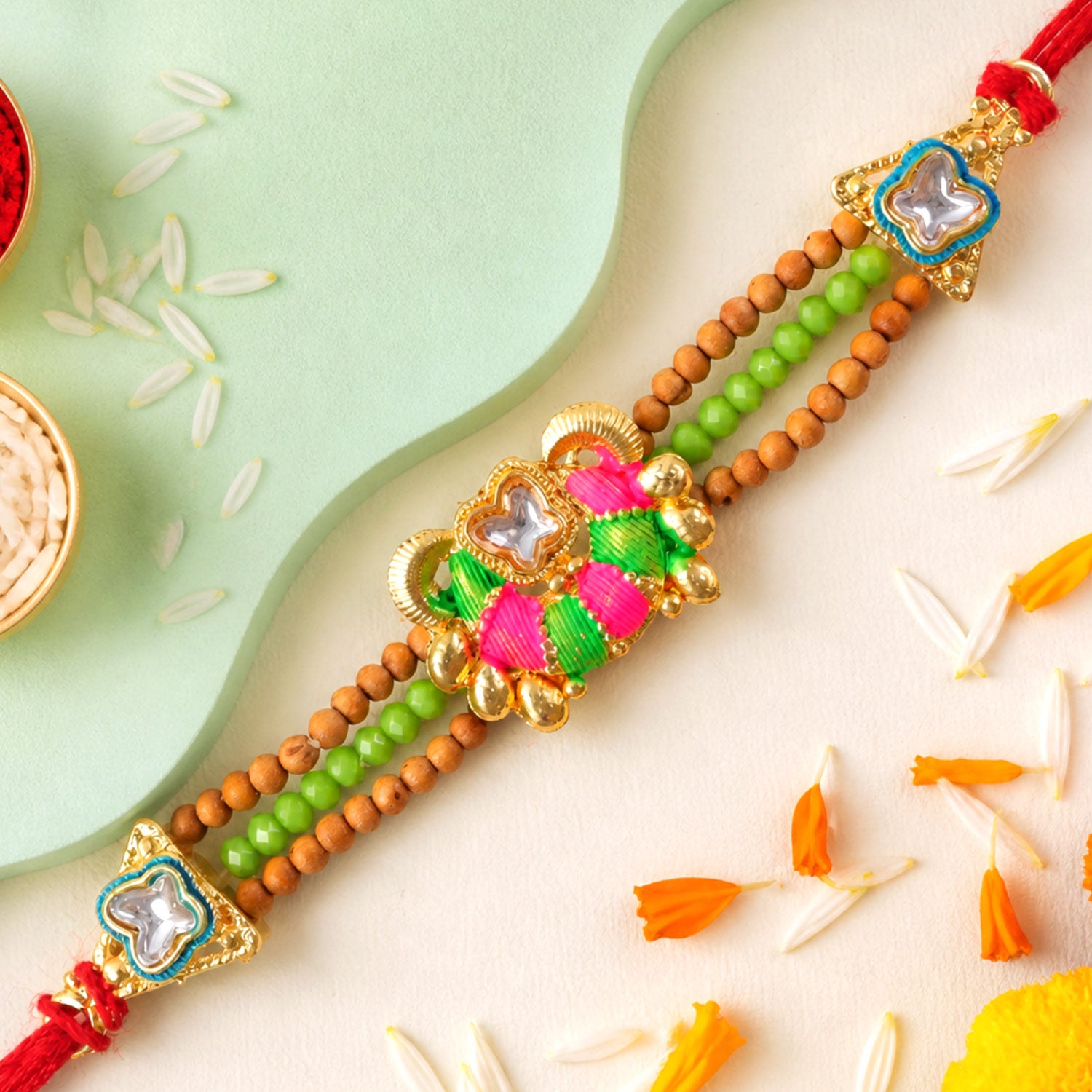 Green Beaded Floral Rakhi with Pink Center and Colorful Festive Gifting Elegance