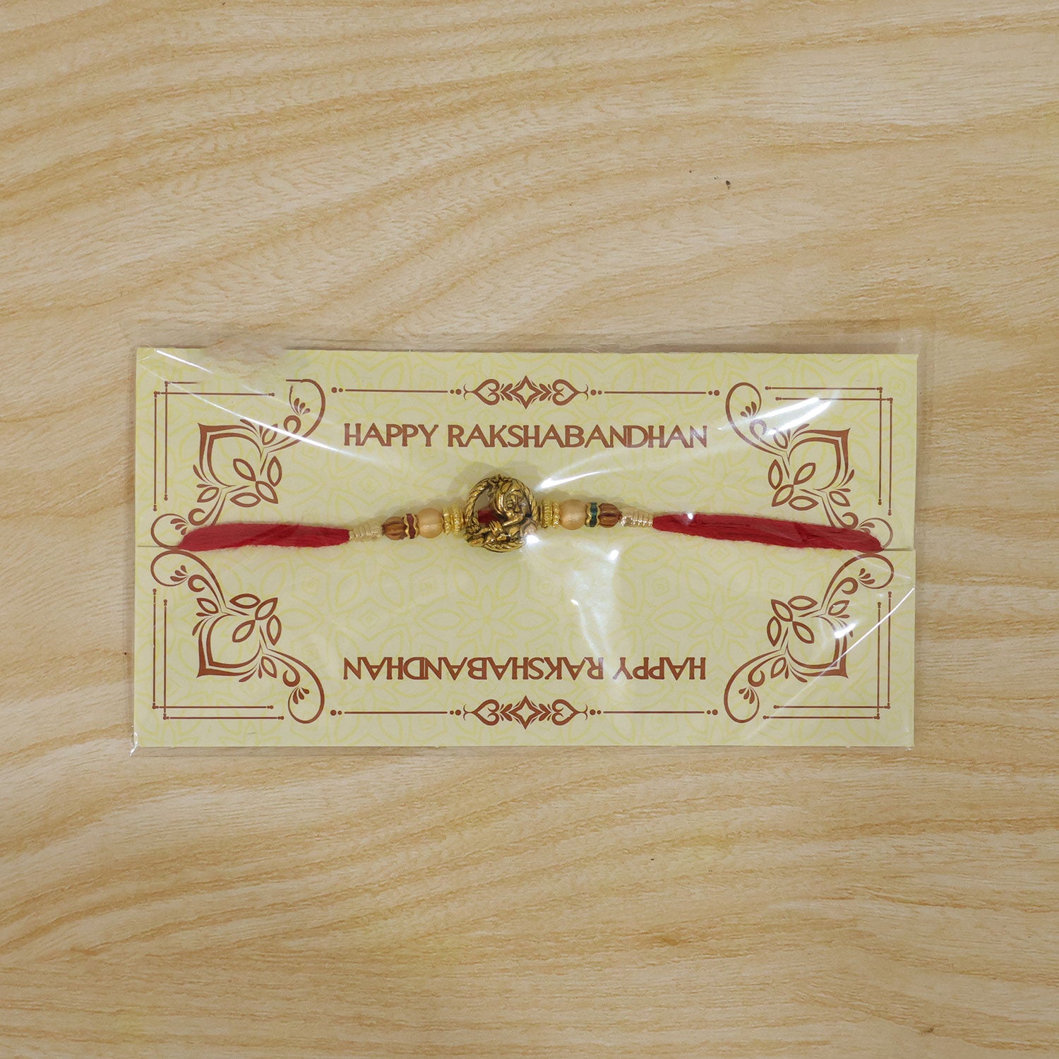 Kanha Krishna Name Devotional Rakhi with Golden Flute Detail and Red Thread