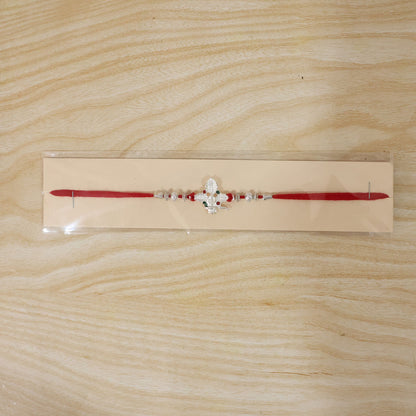 Silver Shivling Leaf Rakhi with Green Stones and Bright Red Thread