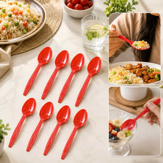 Eight red plastic spoons arranged on a white marble table with food and drinks in the background.