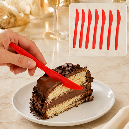 A hand holds a red plastic knife cutting a slice of chocolate cake on a white plate, with six more knives in the background.