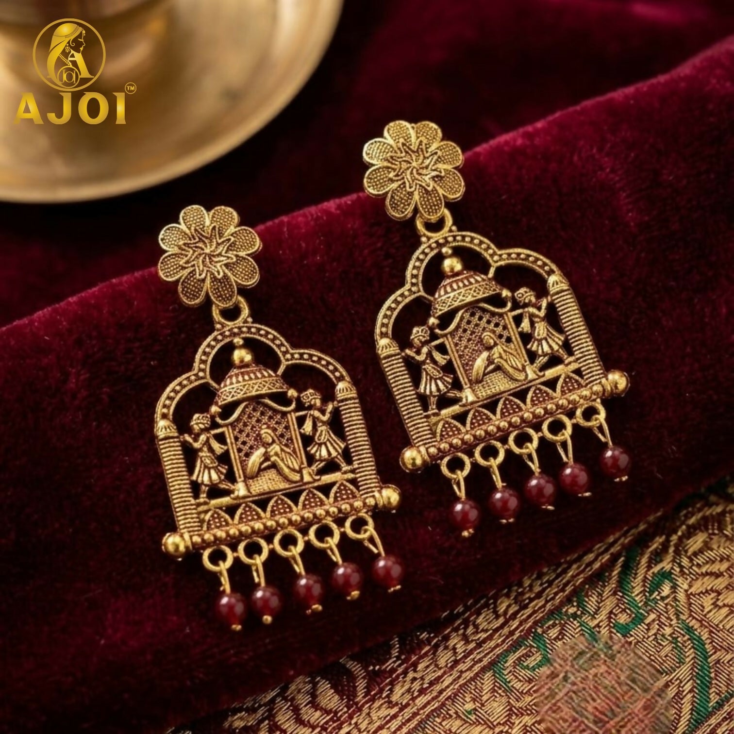 Close-up of maroon pearl drops on antique temple doli earrings