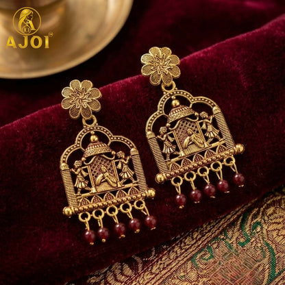 Close-up of maroon pearl drops on antique temple doli earrings