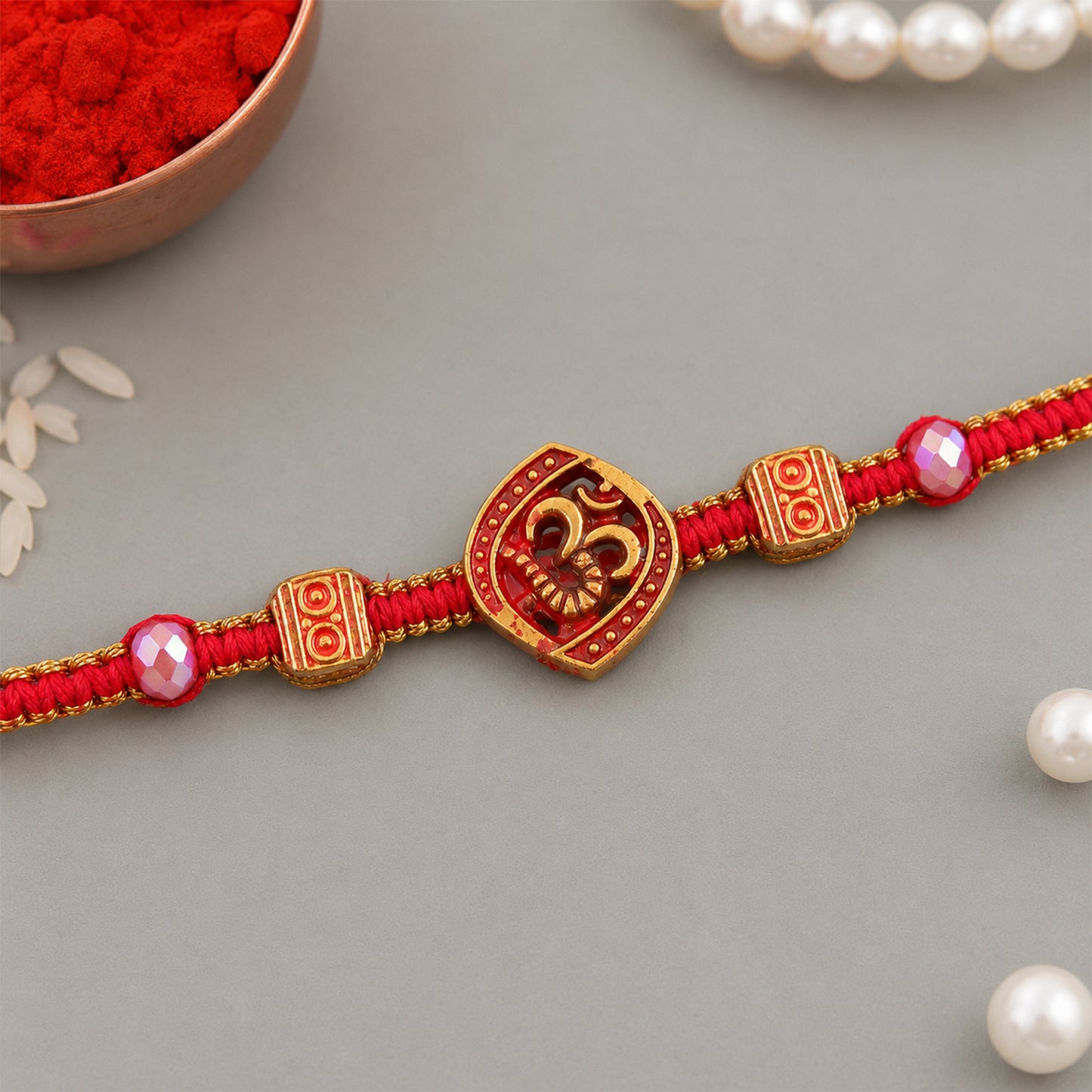 Red Swirl Stone Rakhi with Golden Detail and Beautiful Festive Centre Styling