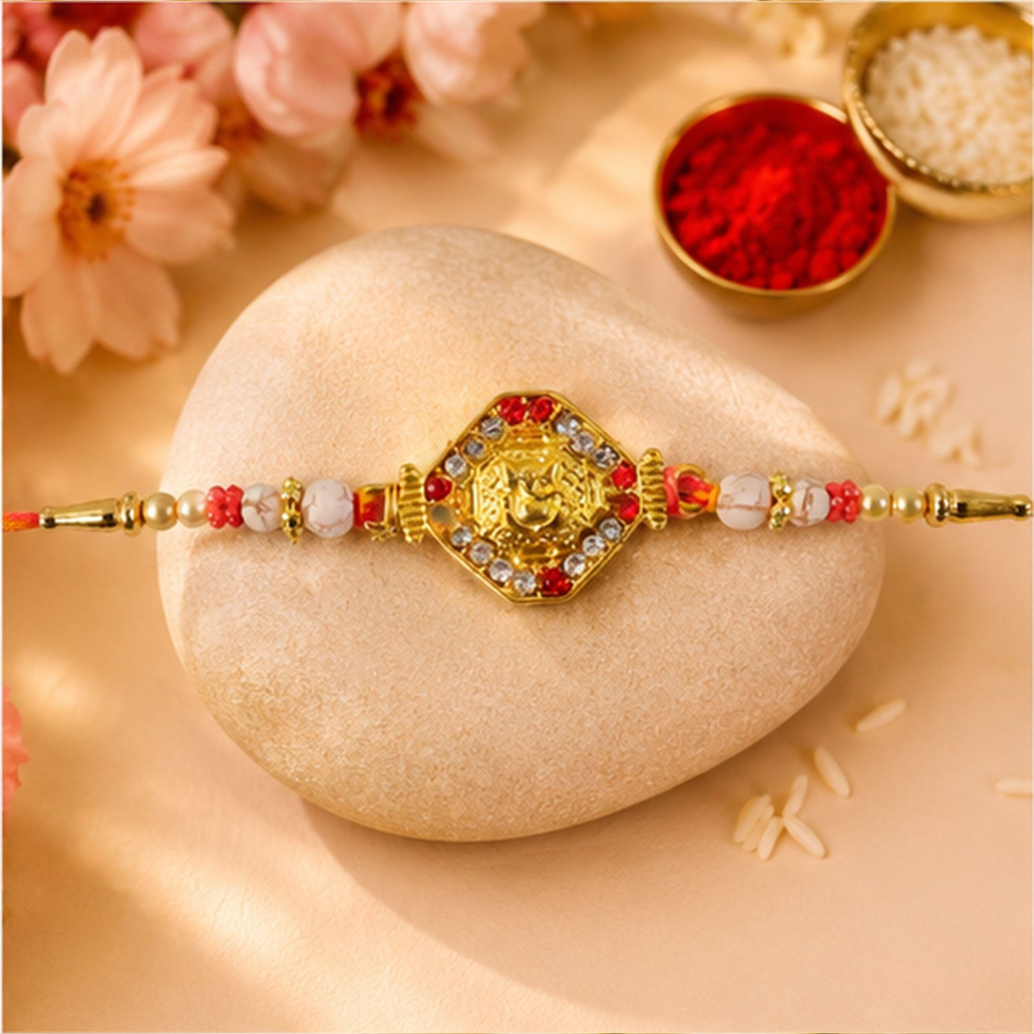 Ganesh Rakhi with Golden Beads and Red-Yellow Thread