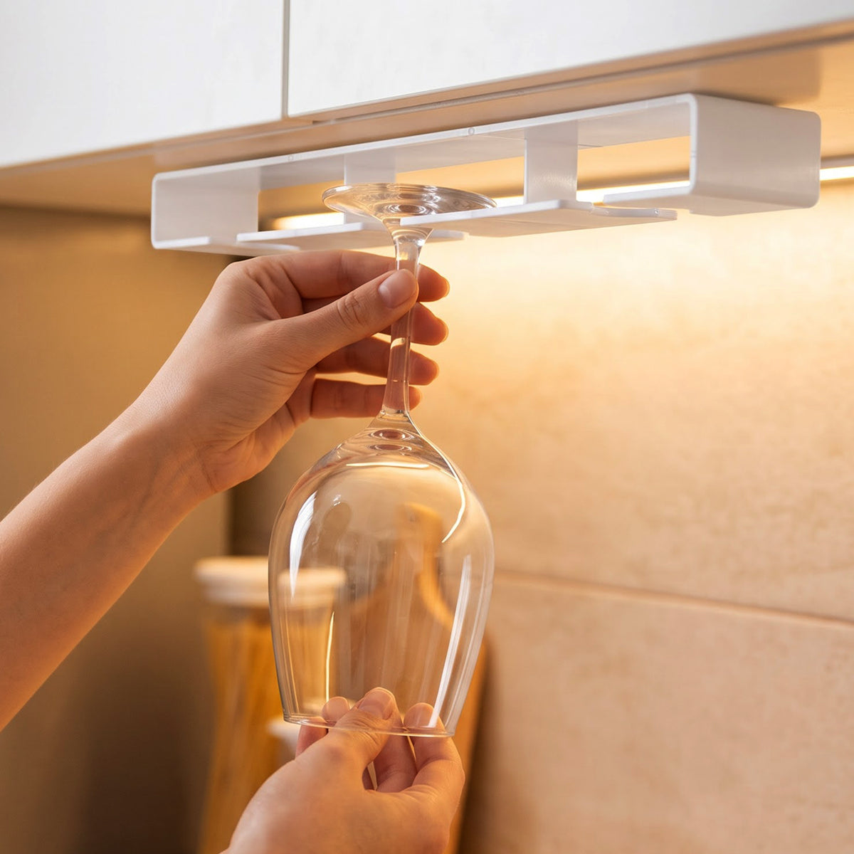 Wine glass holder mounted below kitchen cabinet