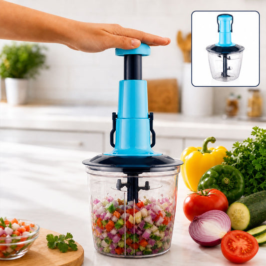 A hand presses down on a blue manual chopper filled with finely diced colorful vegetables on a kitchen counter.
