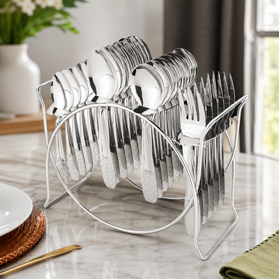 A shiny silver cutlery set, including spoons, forks, and knives, neatly arranged in a metal stand on a marble table.