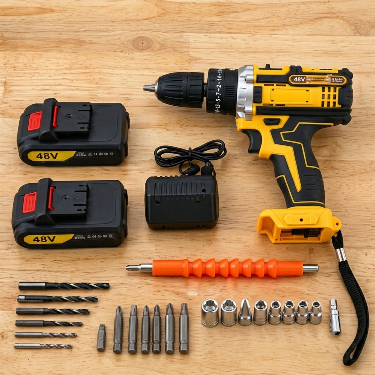 A yellow and black cordless drill, two batteries, charger, and various drill bits are arranged on a wooden surface.