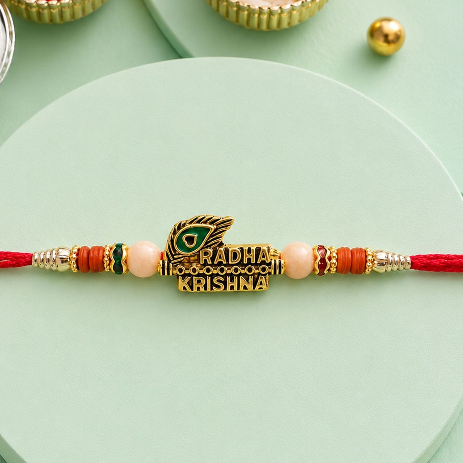 Radha Krishna Peacock Feather Rakhi – Elegant Traditional Design for Brothers