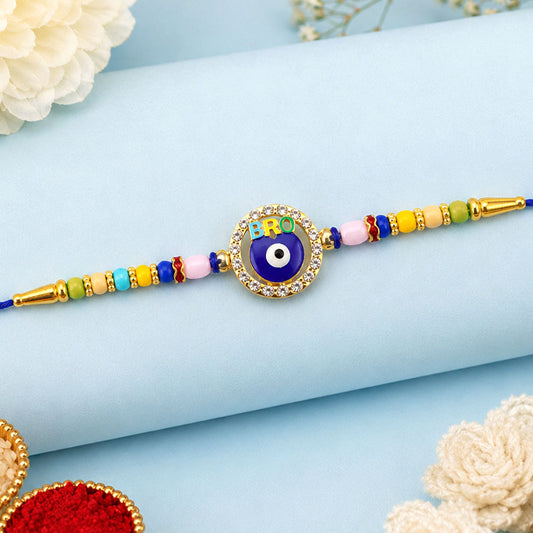 A blue evil eye charm with the word "BRO" at the top is centered on a blue thread with colorful beads and gold accents.