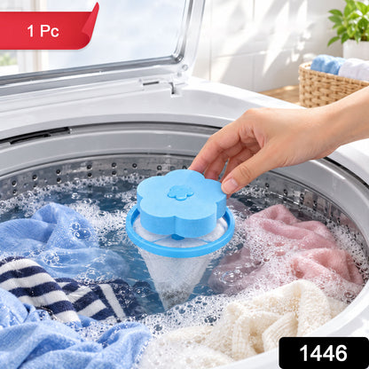 A hand inserts a blue flower-shaped lint filter into a washing machine with various garments and suds.