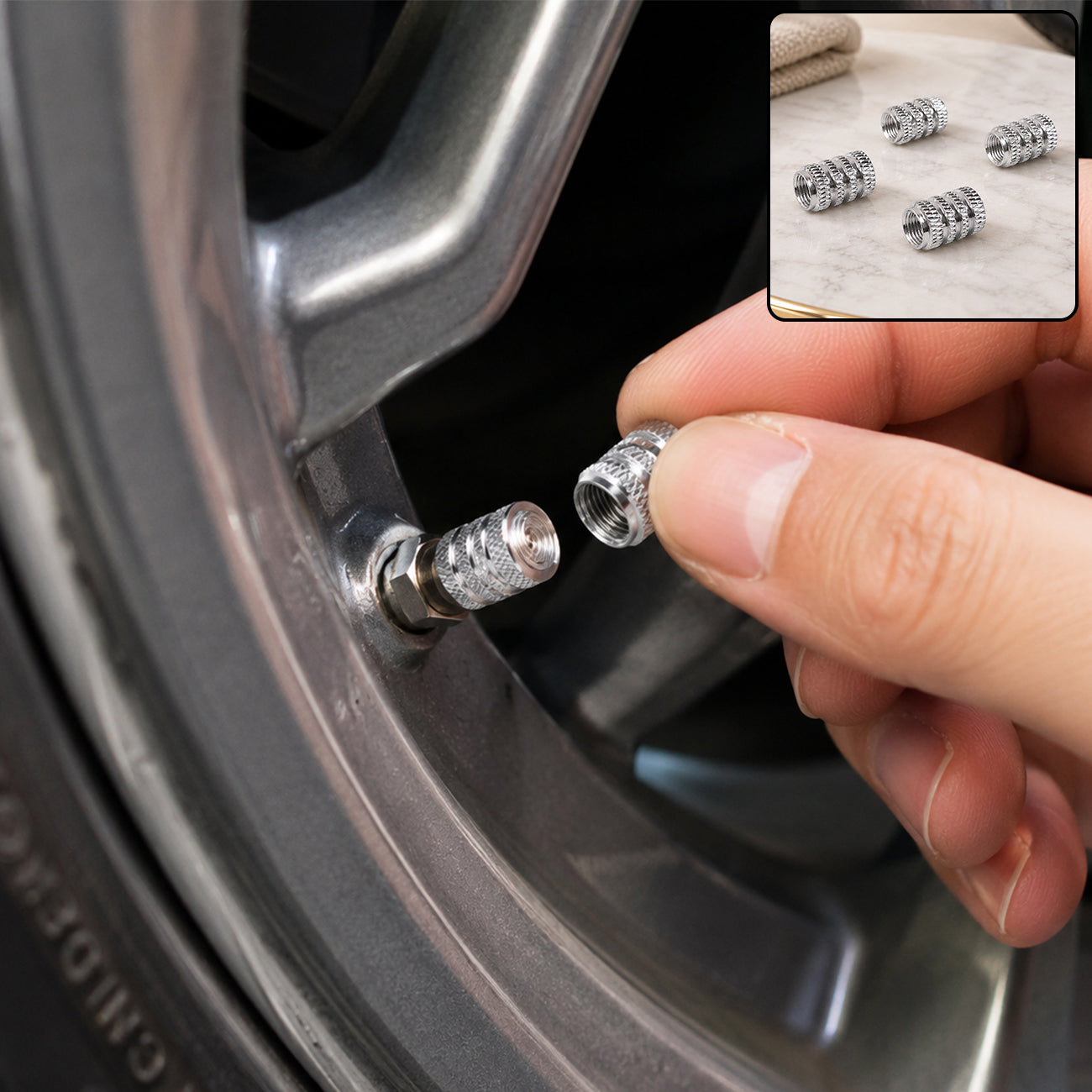 A hand screwing a silver textured valve cap onto a car tire valve stem; inset shows four caps.