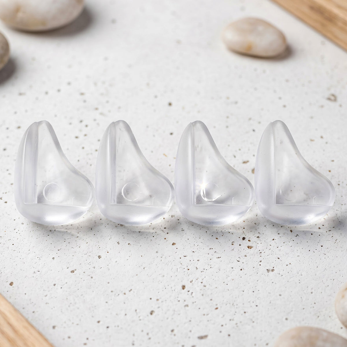 Four transparent table corner protectors
