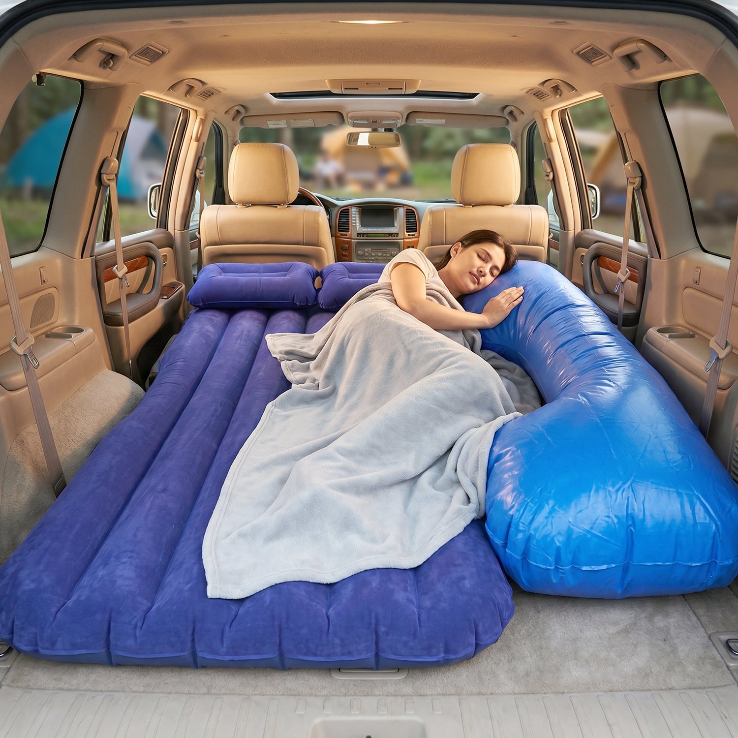 Couple relaxing on Car Air Mattress inside SUV