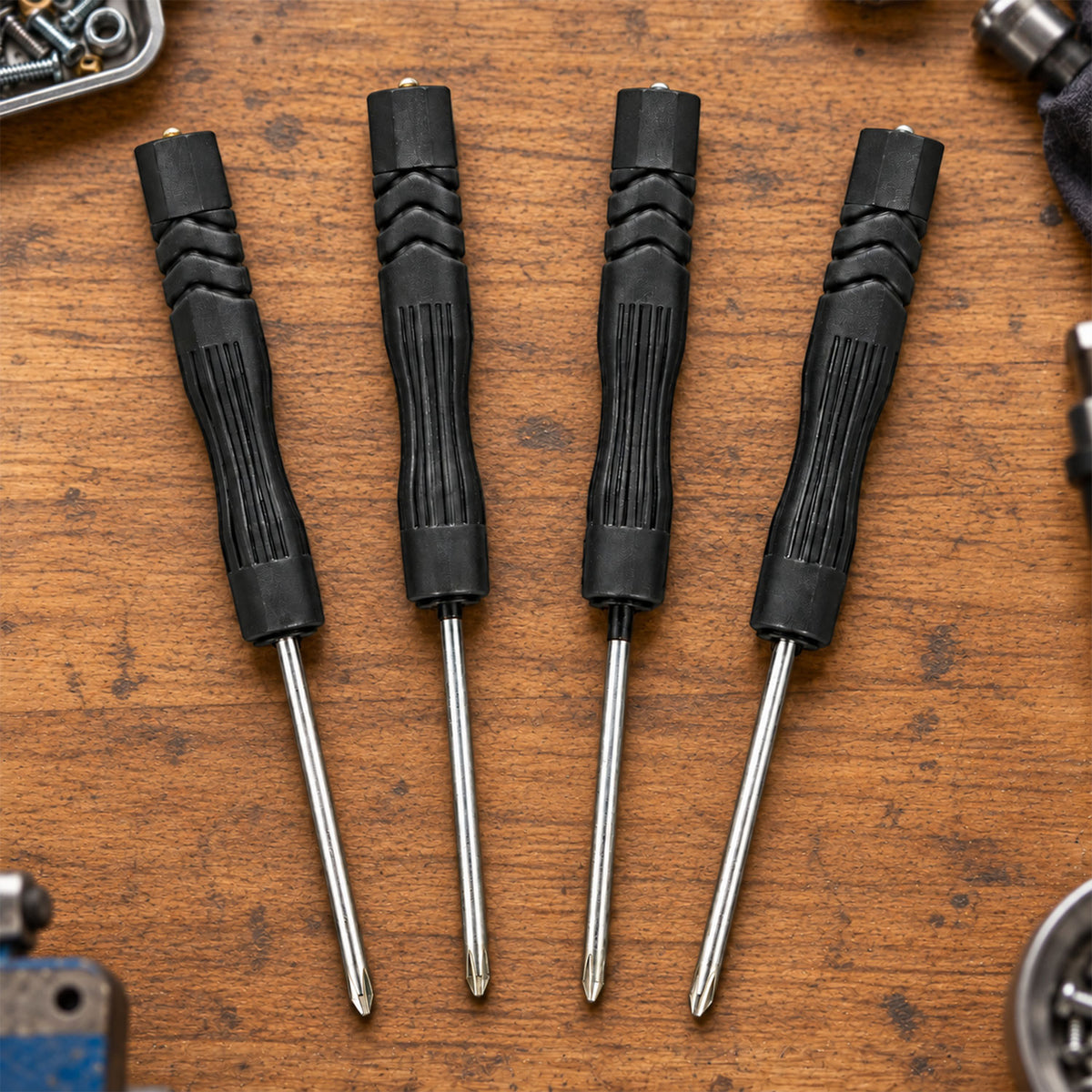 Four precision screwdrivers arranged on work surface