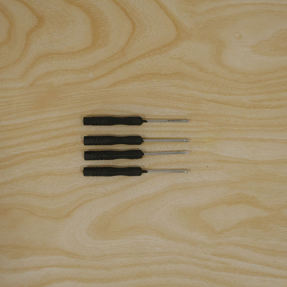 Actual photograph of four mini screwdrivers