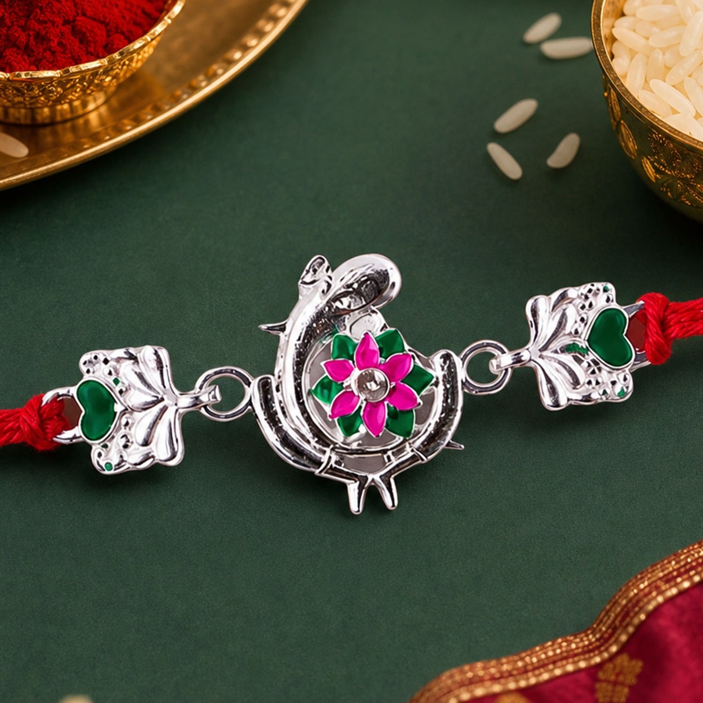 Silver Peacock Flower Heart Rakhi with dori, a traditional design for Raksha Bandhan.