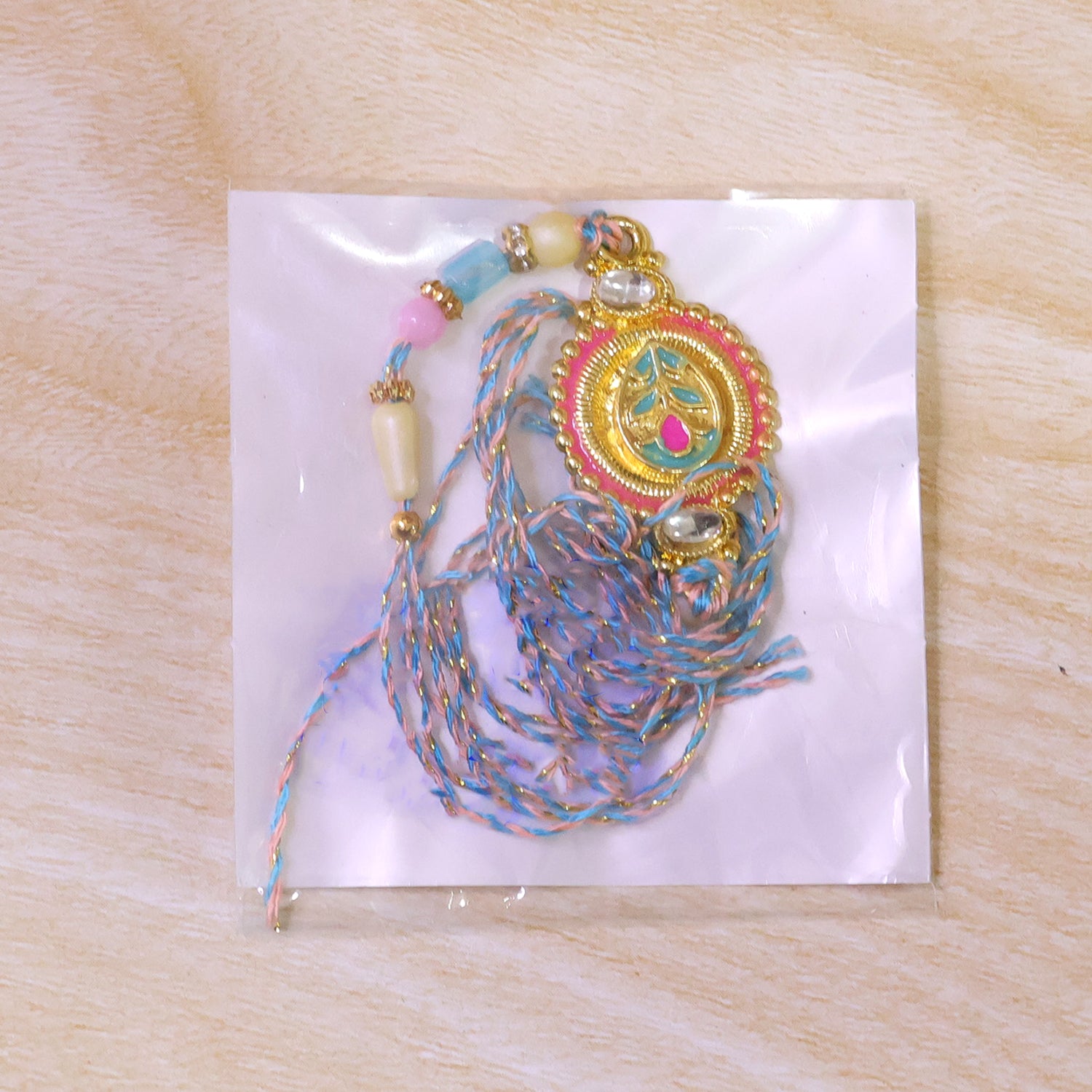 Round Floral Kundan Medallion Rakhi with Pastel Beads