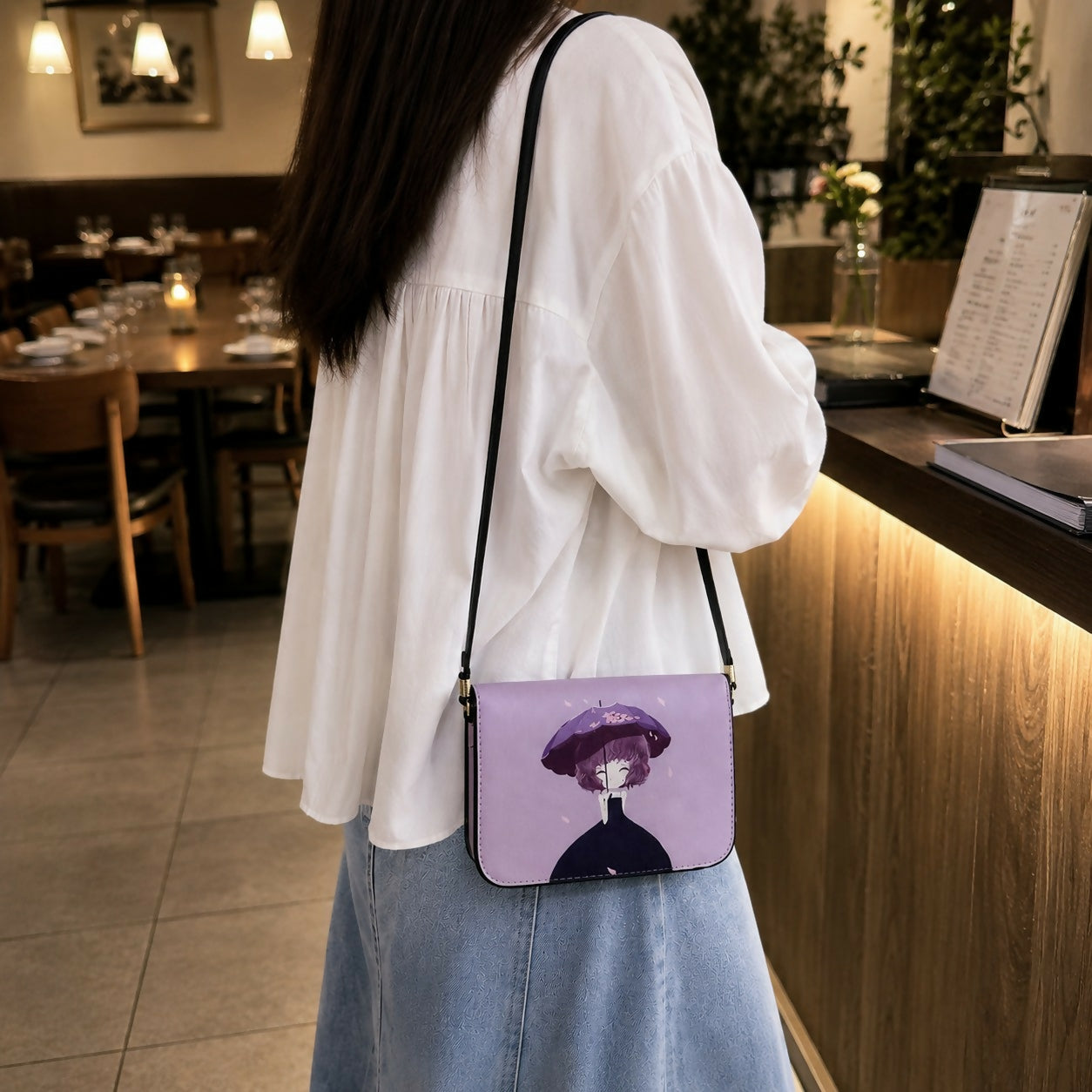 Side view of purple cartoon print crossbody sling bag