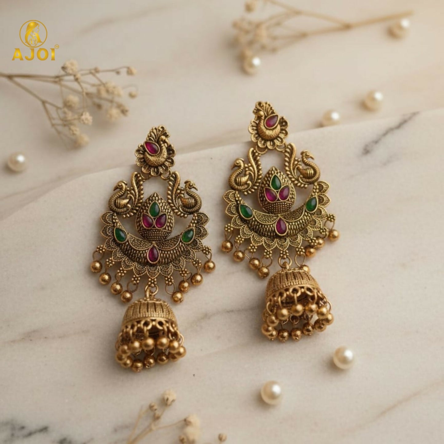 Close-up of green and pink stones on peacock jhumka earrings