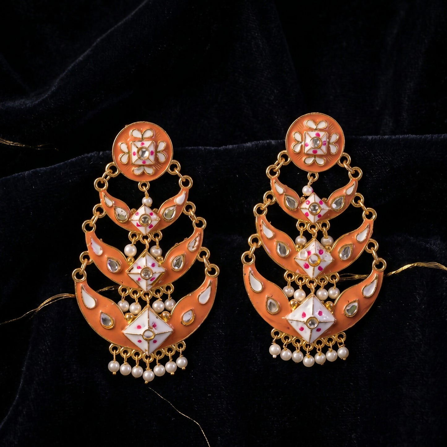 Pearl hanging accents on the peach gold traditional drop earring