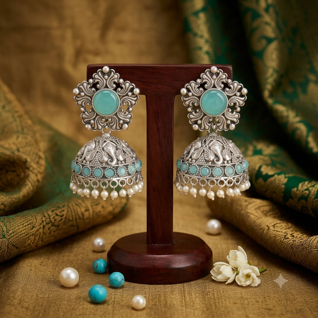 Side view of oxidized silver jhumka earrings with pearls