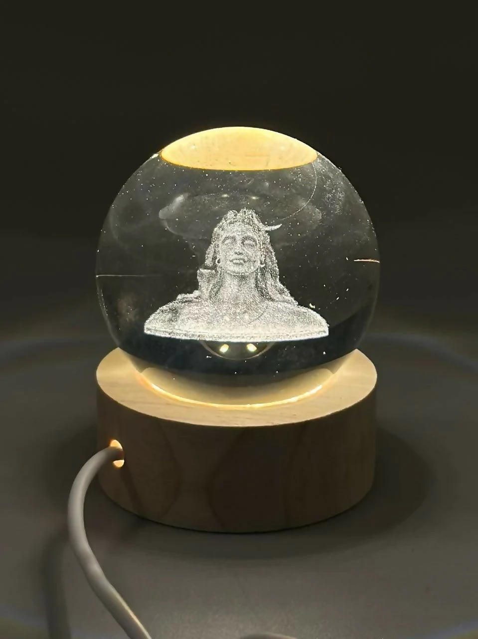 Close-up of 3D Adiyogi Shiva design inside crystal ball lamp