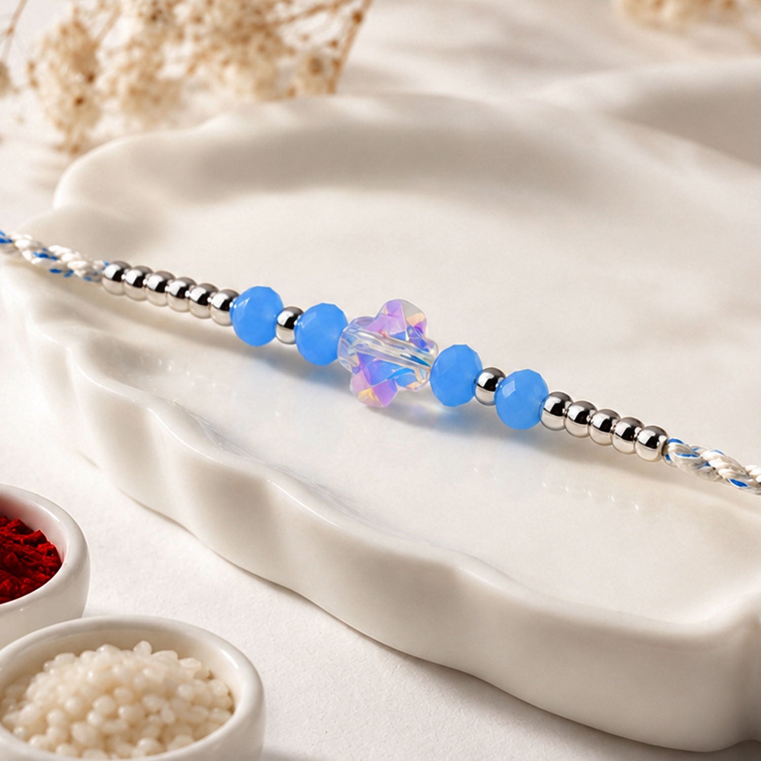 Blue Crystal Bead Rakhi with Round Stone Centre, Silver Highlights and Red Thread