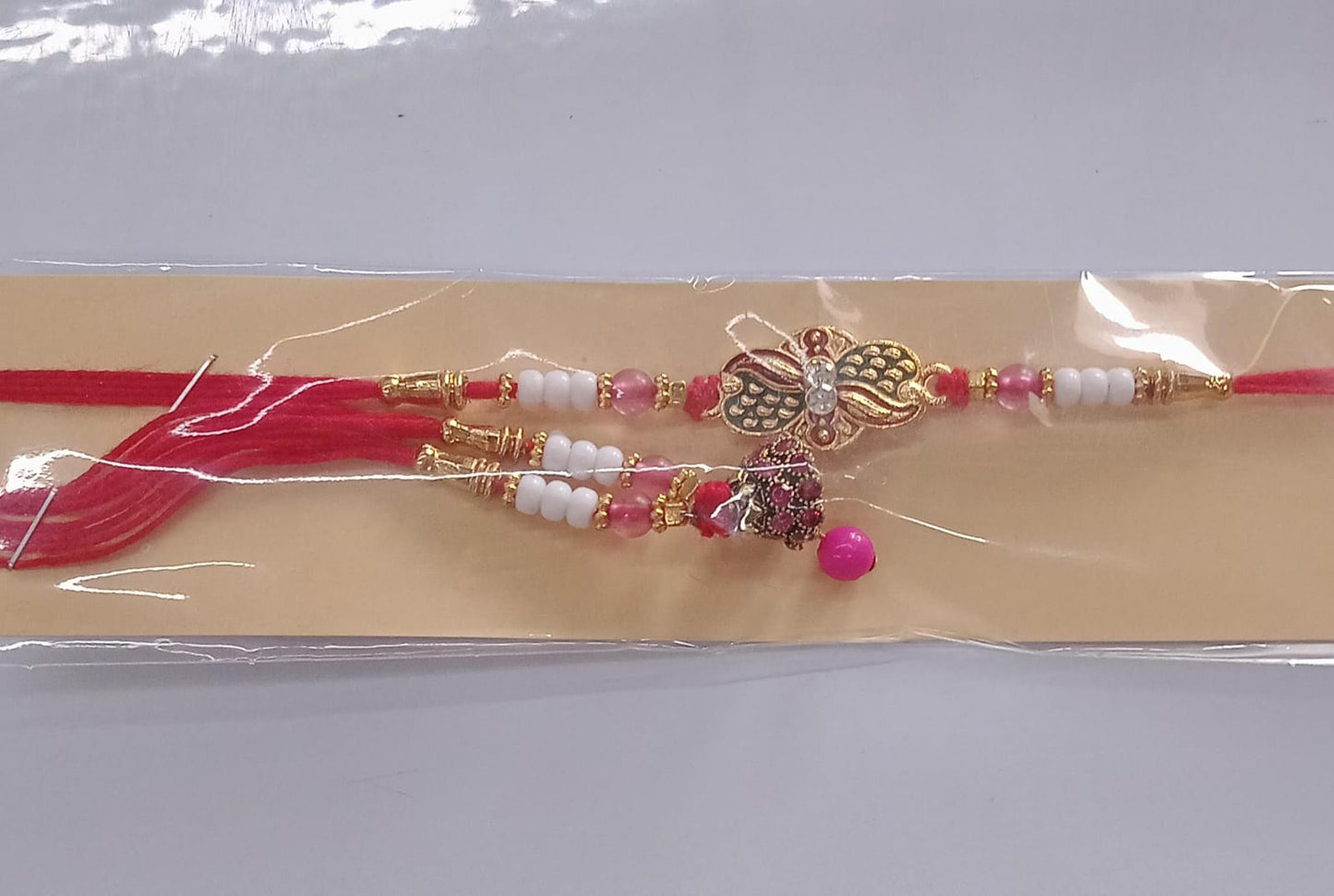 Elegant Bhabhi Lumba Rakhi with Butterfly Design, Beaded Tassels & Pink Stone Work