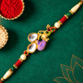 Floral Kundan Pendant Rakhi with Purple Peacock Accent