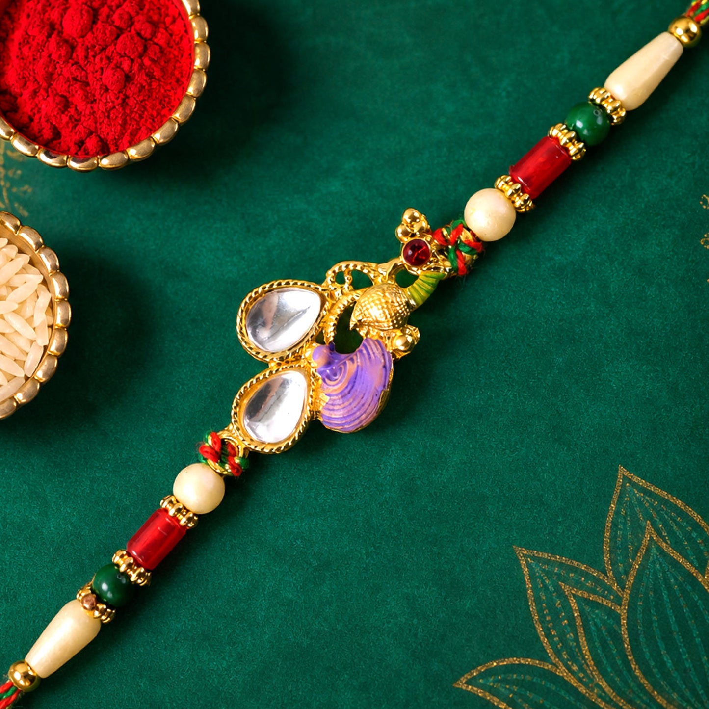 Floral Kundan Pendant Rakhi with Purple Peacock Accent