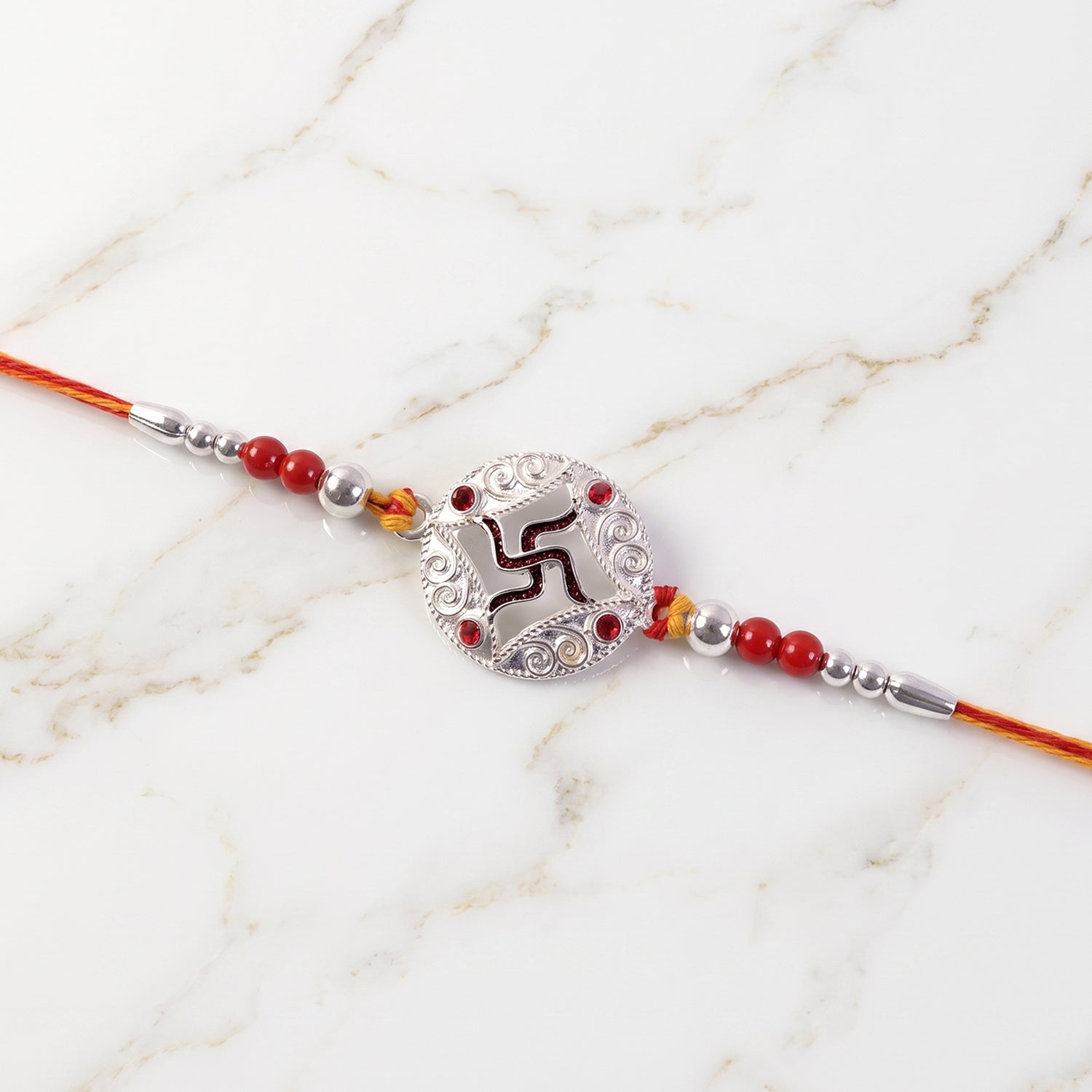 Silver Swastik Stone Rakhi with Red Thread and Handmade Look