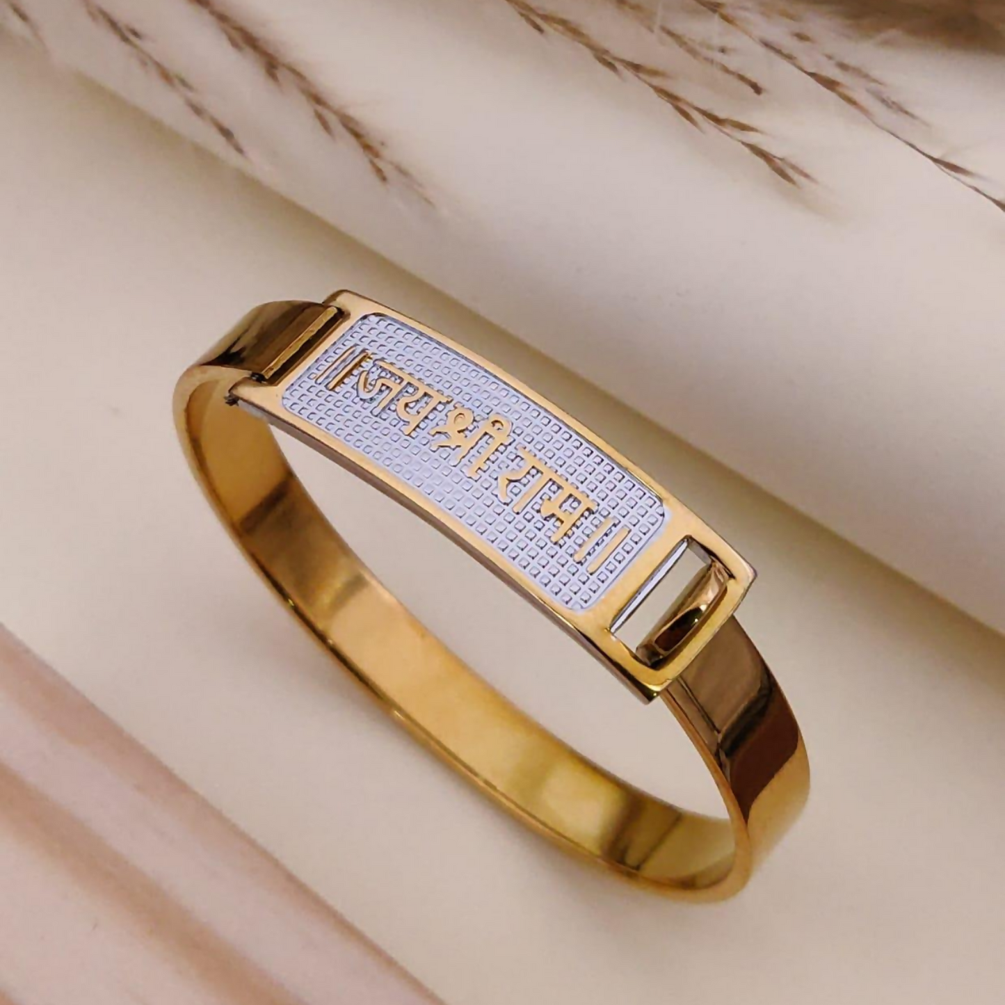 Men's kada bracelet showcasing gold & silver tones