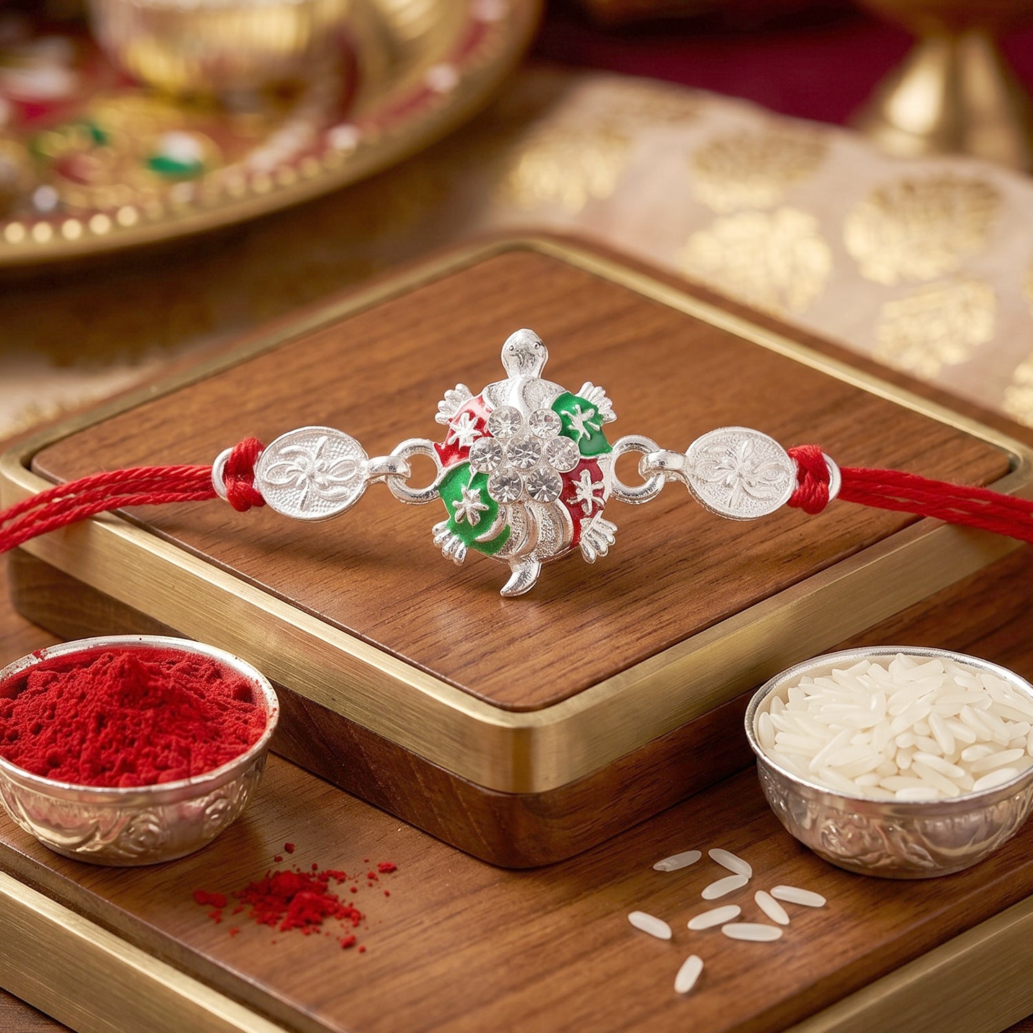 Turtle Rakhi with Red Thread and Crystal Embellishments
