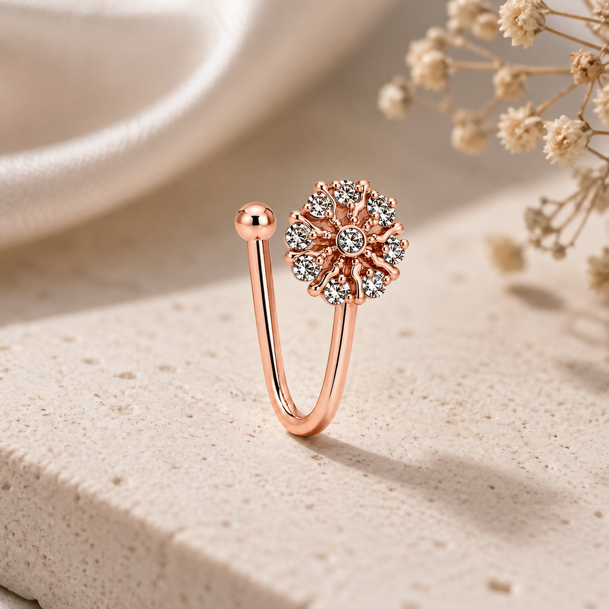 Elegant nose ring in rose gold with flower design and sparkling stones