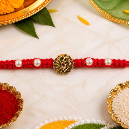 Red Braided Rakhi with Antique Gold Om Pendant and Lustrous Pearls